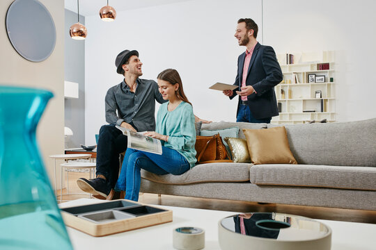 Couple talking to salesman in furniture store