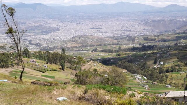 Elevated view of Ambato city and Andean mountains in Ecuador showcasing urban landscape