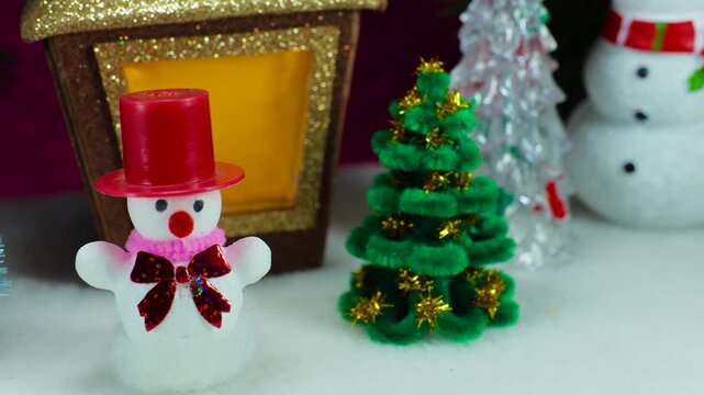 Close-up of a snowman near a Christmas lantern
