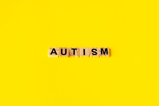 Autism word on a yellow background - minimal aesthetics. Neurodiversity concept.