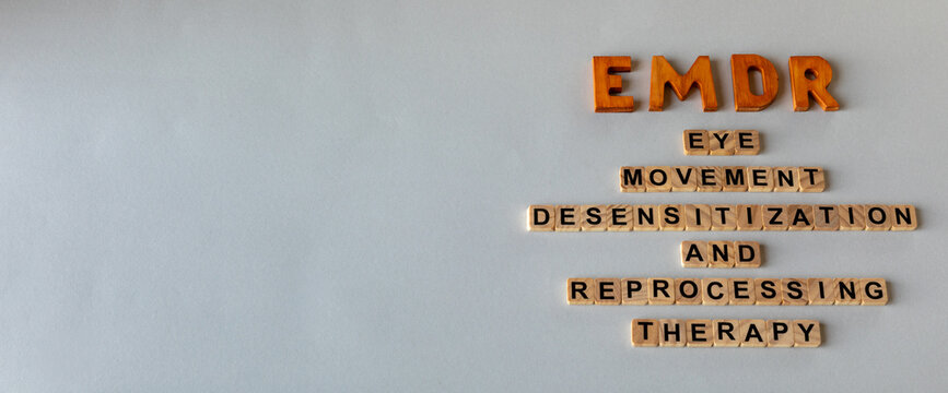 EMDR psychotherapy: abbreviation and its individual words on a gray background. Banner with copy space, mental health concept.