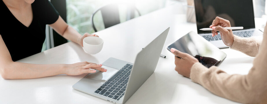 Businesswomen working together with laptop and digital tablet in office
