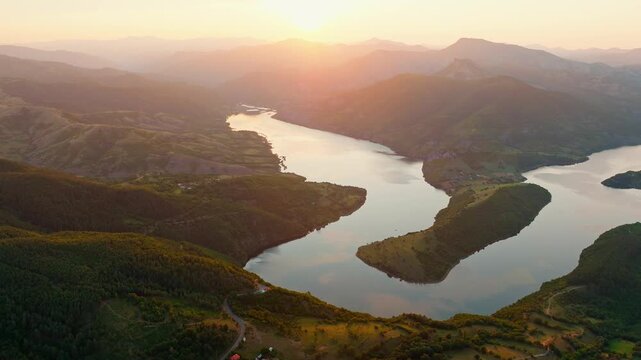 Kardzhali reservoir bend Arda river meander green mountain canyon aerial panoramic drone view sunset golden hour summer landscape travel destination background Bulgaria.