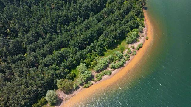 Shiroka polyana lake top view aerial shot texture sandy shoreline turquoise water green forest pattern graphic curve creative background summer concept Bulgaria.