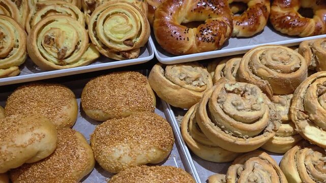 Table full with fresh pastry products. All inclusive breakfast buffet of hotel. Tasty croissants, buns, and muffins at the hotel breakfast buffet. A variety of freshly made pastries and bakery product