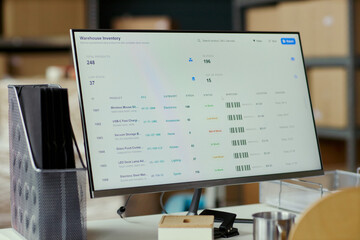 Fototapeta na wymiar Close up of desktop monitor displaying warehouse inventory dashboard, tracking stock levels, barcodes, product records for logistics management, retail operations, supply chain marketing