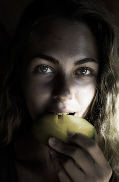 Beautiful Green-Eyed Woman Eating Mango