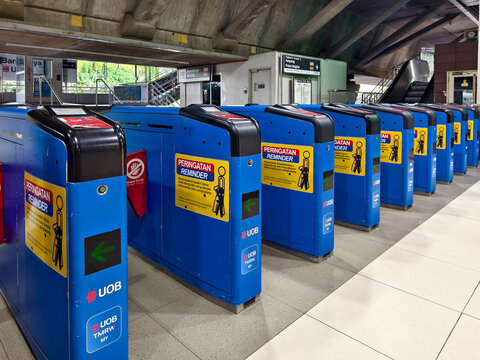 Kuala Lumpur, Malaysia - March 9, 2026: Blue ticket gates and entrance barriers inside Bank Negara KTM Komuter Station
