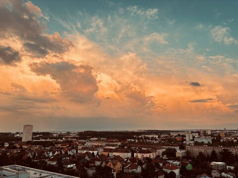 Urban skyline at sunset with vibrant clouds over cityscape  