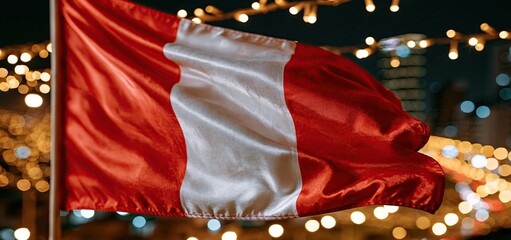 Fototapeta premium At night in a lively city, the Peruvian flag waves proudly, symbolizing national pride and cultural celebration.