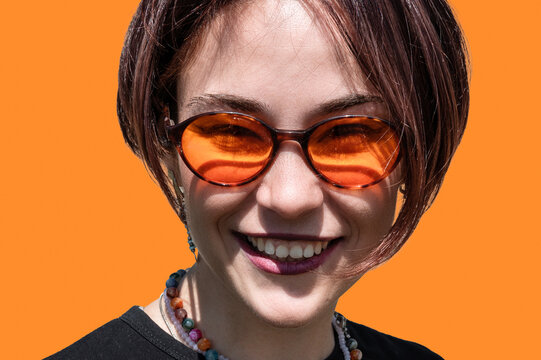 Close Up Portrait of Happy Smiling Young Woman Looking at Camera