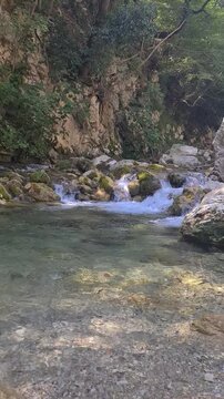 Waterfall Capelli di Venere, small mountainside cascade surrounded by vegetation, close to a ruined mill, Casaletto Spartano, Province of Salerno, Italy
