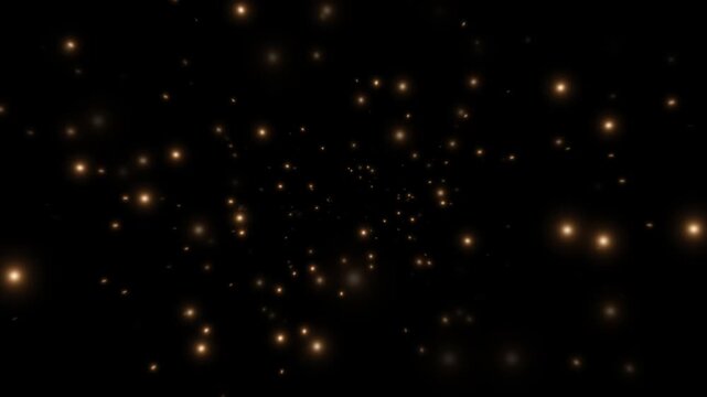 Golden sparkling particles flying outward from the center. Light effect on a black background. 4K video.