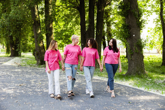 Women holding hands promoting breast cancer awareness