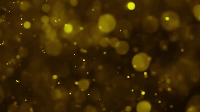 Golden particles shimmering and floating in dark liquid, abstract background