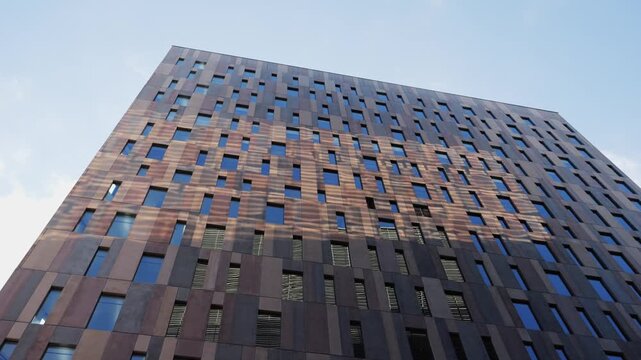 Modern glass office scyscraper buildings beautifully reflecting the clear blue sky in an urban environment