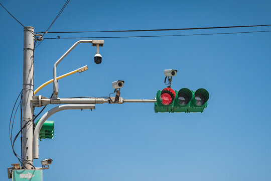 CCTV and surveillance cameras mounted on traffic signal pole with electric lines and LED street light in Taipei road, Taiwan, highlights smart city innovations to monitor real-time transport mobility