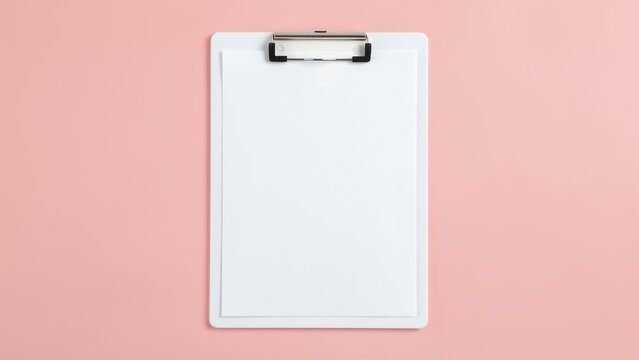 overhead flat lay blank clipboard paper on pastel blush pink background for planning productivity mockups fresh clean organization concept