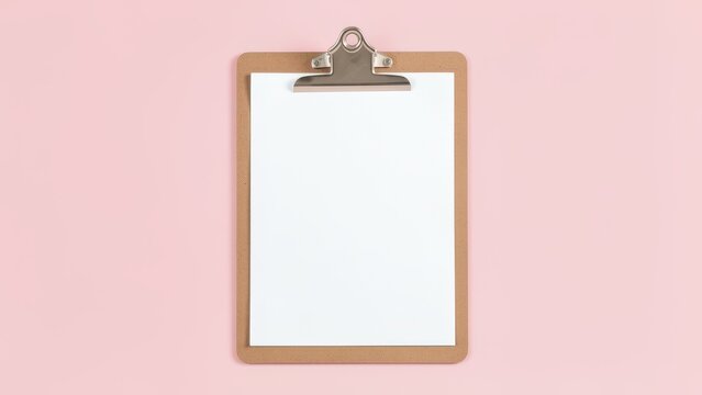 blank white paper on clipboard mockup pastel pink background for productivity planning and fresh start concept studio shot