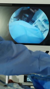 Clinical closeup of minimally invasive surgery viewed through endoscope in surgery room. Surgeons uses micro camera to examine patient vertical shot