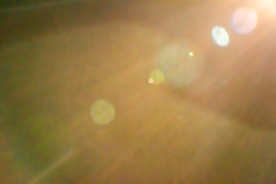 Warm lens flare overlay with light leaks and bokeh