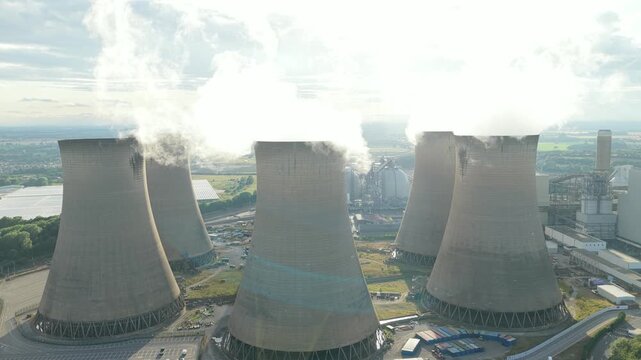 Power Plant Cooling Towers Release Massive Steam Plumes on a Bright Day