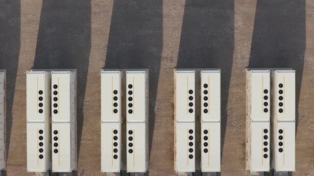 Industrial Battery Energy Storage Modules Organized on a Sunny Outdoor Lot