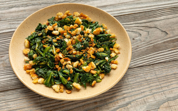 Traditional Italian cicoria ripassata alla romana: saut&eacute;ed chicory greens with crunchy, browned breadcrumbs. 