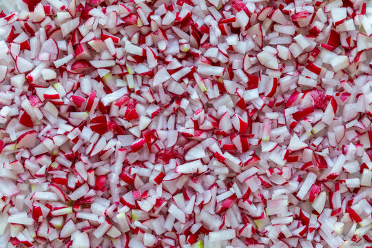 Food background texture of finely shredded and matchstick cut raphanus sativus radish pieces for cottage cheese salad.