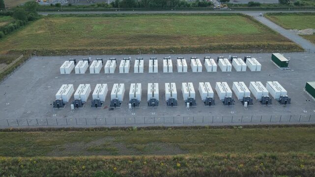 White Battery Storage Containers and Power Units Arranged in an Expansive Outdoor Facility