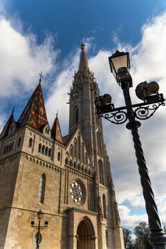 Gothic Church With Ornate Tower and Street Lamp