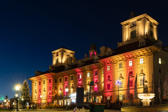 Illuminated Historic Building at Night With Fountain