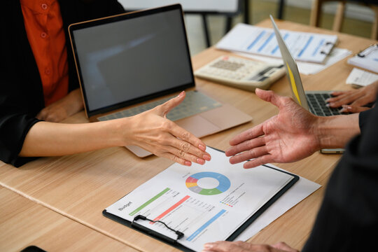 Collaboration Various Departments Close Up of Business Professionals Discussing Budget Report with Charts at Office Meeting Table