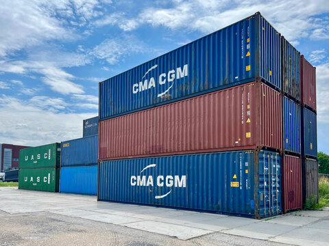 Poland - 07.10.2026: Stack of CMA CGM and UASC Shipping Containers at Container Terminal Under Blue Sky &ndash; Global Logistics, Freight Transportation and International Trade