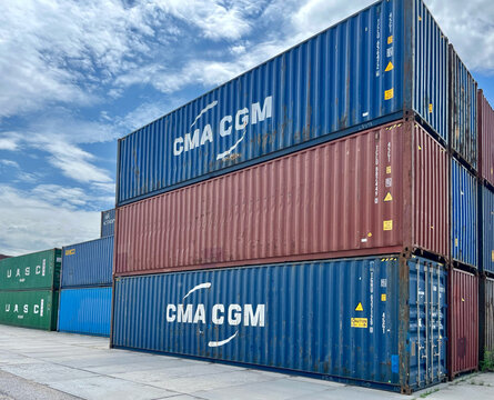 Poland - 07.10.2026: Stack of CMA CGM and UASC Shipping Containers at Container Terminal Under Blue Sky &ndash; Global Logistics, Freight Transportation and International Trade