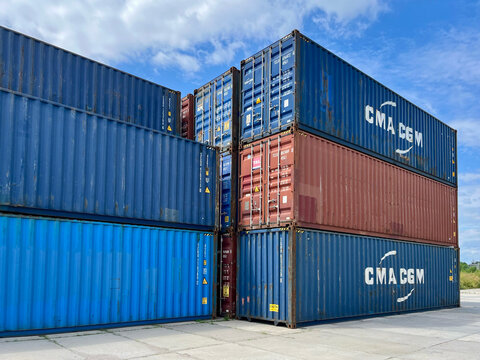 Poland - 07.10.2026: Stack of CMA CGM and UASC Shipping Containers at Container Terminal Under Blue Sky &ndash; Global Logistics, Freight Transportation and International Trade