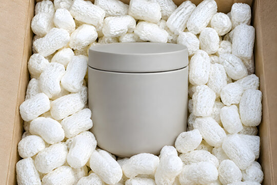 Close-up of consumer goods nestled in water-soluble organic cornstarch protective packaging peanuts.