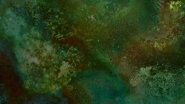 Abstract timelapse of copper patina formation during oxidation. Colorful macro texture with green, blue, orange and red corrosion patterns evolving across a metallic surface
