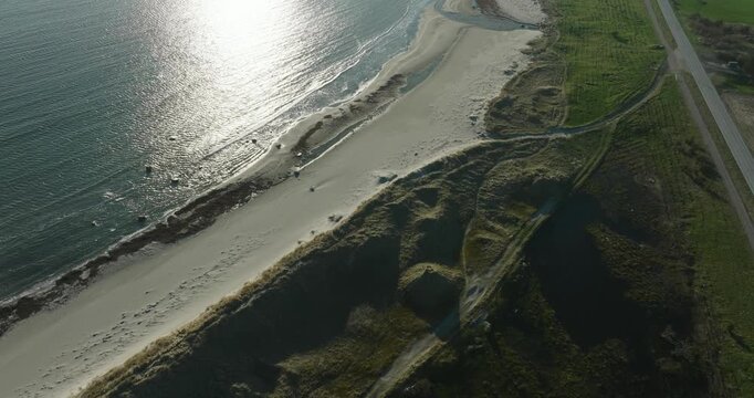 Coastal beach with pebbles and tidal pools at Vestbygd Norway in slow motion