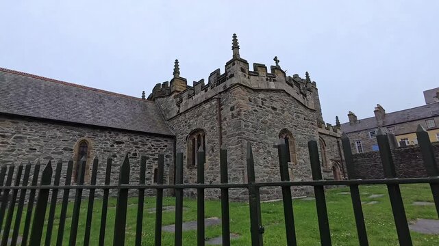 Welsh St Cybi's church Holyhead outside passing iron graveyard railings historical building