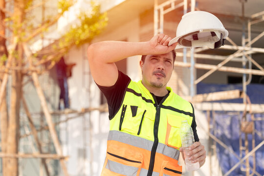 Outdoors worker impact from Heatwave in Europe, Engineer male construction builder sweating
