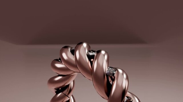 Camera pulling back, braided rose gold ring rotating up on studio table, showing gems gleaming