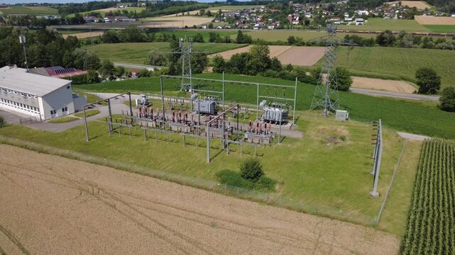 Aerial orbit of an electrical substation in rural countryside