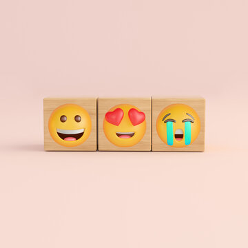 Wooden cubes balancing different emotion emojis
