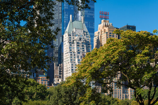 New York City, NY, USA &ndash; August 31, 2025: View of Essex House and Hampshire House historic hotels rising above the trees of Central Park South in Midtown Manhattan in summer