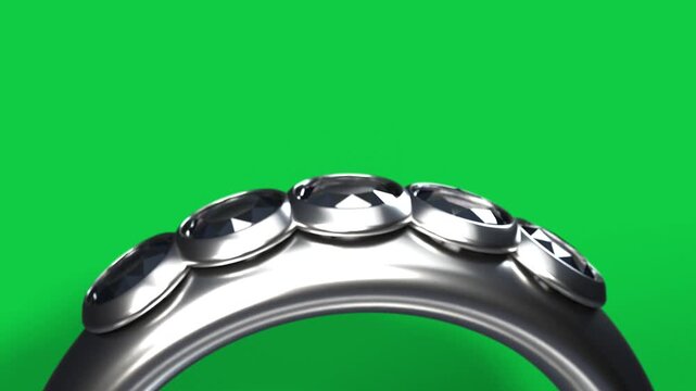 Polished ring sliding and rotating after camera pullback, showing faceted gems, glints on clear bg