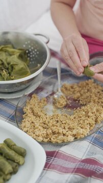 Close-up of making traditional Turkish stuffed grape leaves sarma