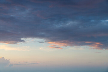 Fototapeta premium Colorful sunset sky with orange dramatic clouds.