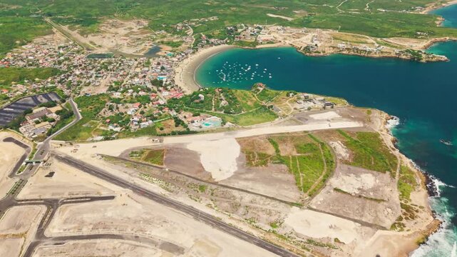 Drone's view capturing the coastal town of ayangue, with its natural bay and surrounding landscape