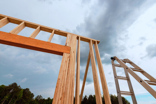 Construction of wooden structure with tall ladder